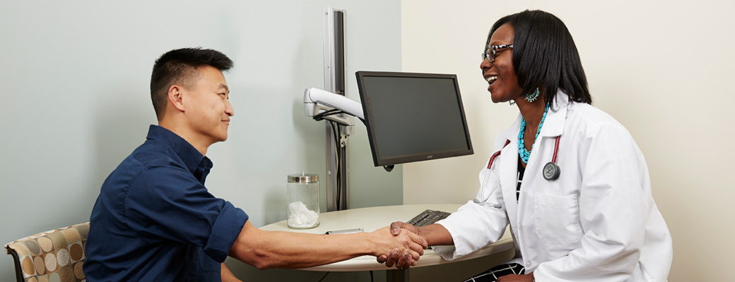 Patient shaking hands with doctor in an onsite health center