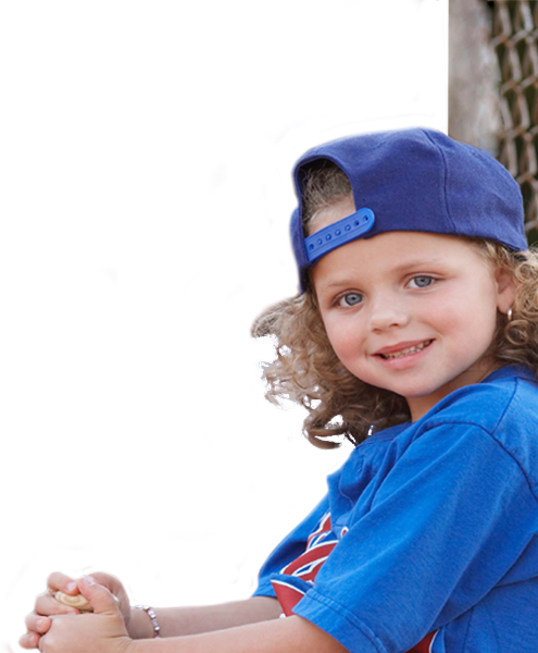 Little girl at baseball game smiling at camera
